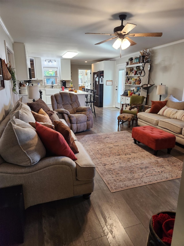 living room featuring ornamental molding, sink, ceiling fan, and light hardwood / wood-style floors