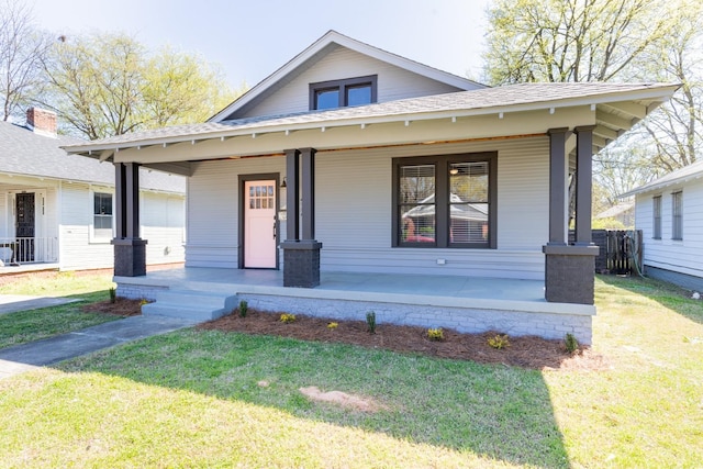 bungalow featuring a front yard and a porch