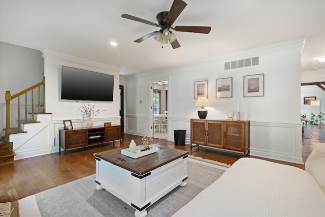 living room with ornamental molding, ceiling fan, and dark hardwood / wood-style flooring