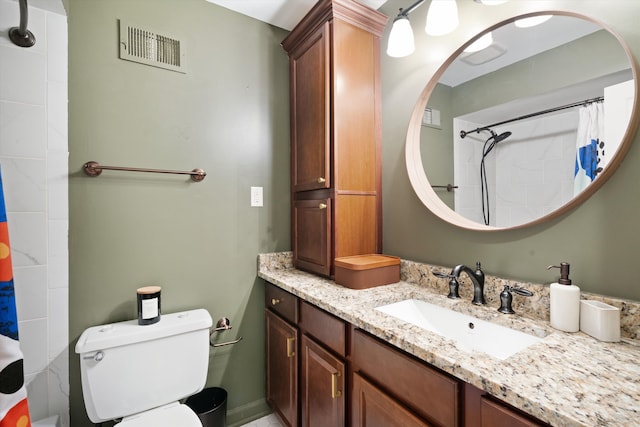 bathroom featuring vanity, toilet, and a shower with shower curtain