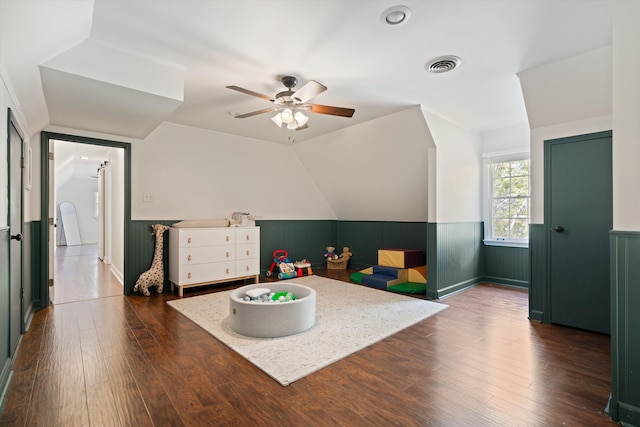 rec room with vaulted ceiling, dark hardwood / wood-style floors, and ceiling fan