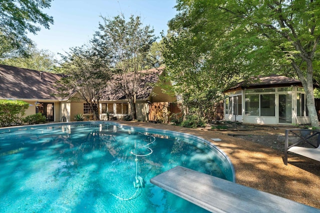 view of pool featuring a diving board