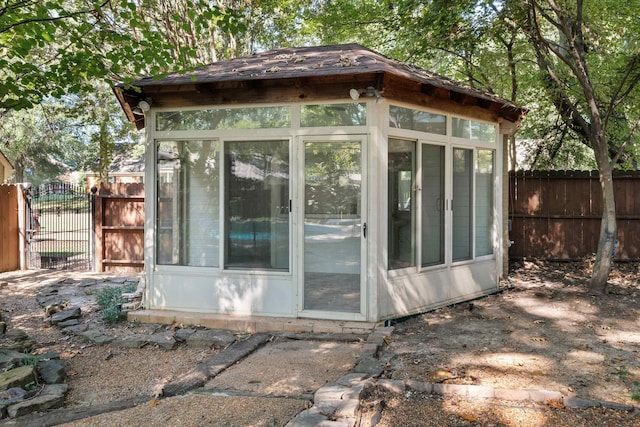 view of outdoor structure featuring a sunroom