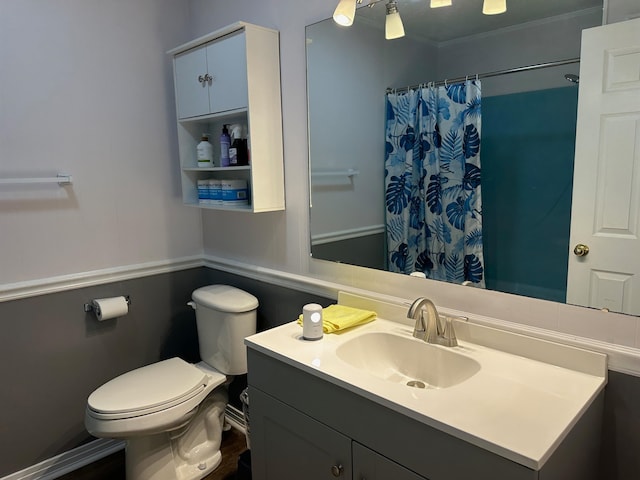 bathroom featuring vanity, toilet, crown molding, and a shower with curtain