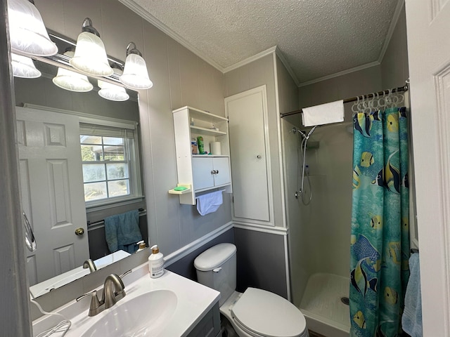 bathroom with a textured ceiling, a shower with shower curtain, toilet, vanity, and ornamental molding