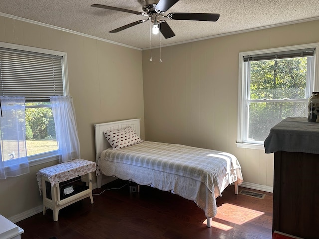 bedroom with ceiling fan, multiple windows, and dark hardwood / wood-style flooring