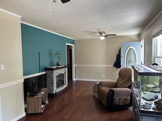 living area with ornamental molding, dark hardwood / wood-style floors, a textured ceiling, and ceiling fan