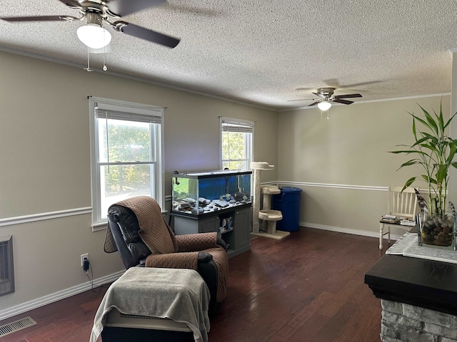 interior space with ceiling fan, a textured ceiling, and dark hardwood / wood-style floors