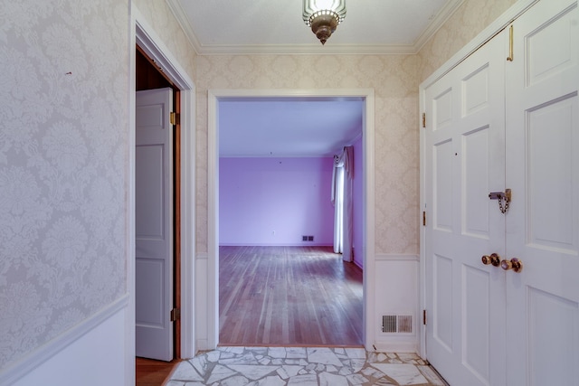 corridor featuring light wood-type flooring and crown molding