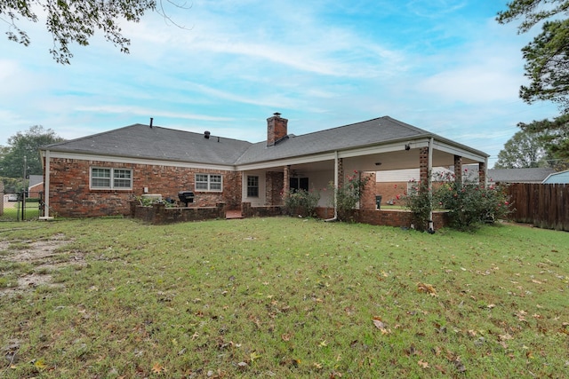 back of house featuring a yard