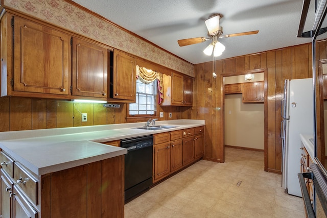 kitchen with wood walls, white fridge, a textured ceiling, and black dishwasher