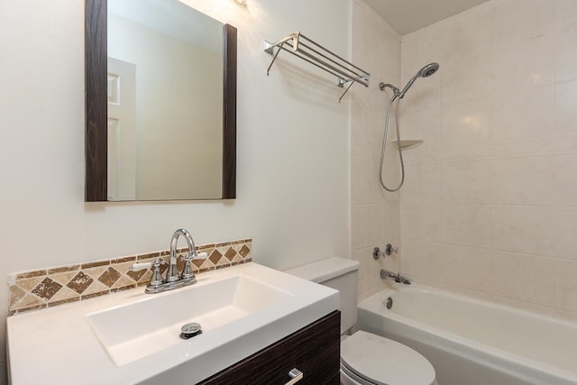 full bathroom featuring vanity, toilet, and tiled shower / bath combo