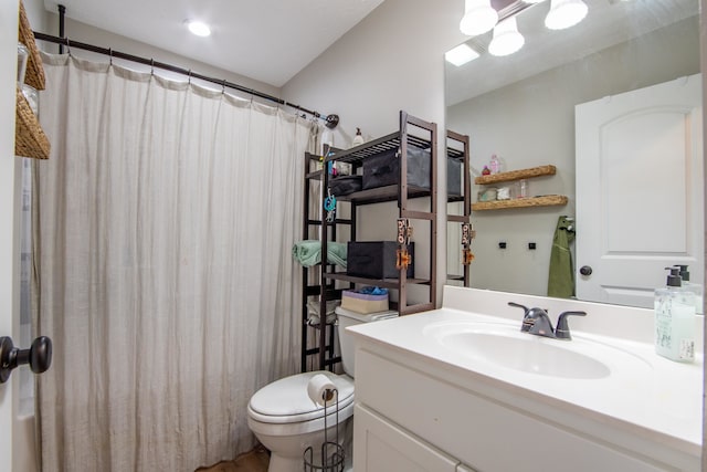 bathroom featuring vanity, toilet, and walk in shower