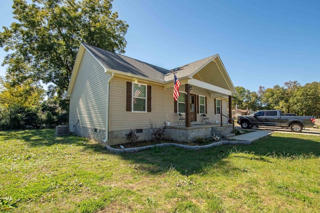 view of front of house featuring central AC and a front lawn