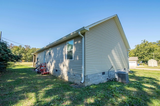 view of property exterior featuring a storage unit, central AC unit, a garage, and a lawn