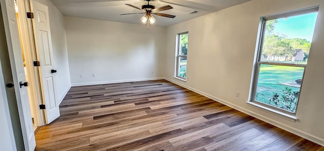 spare room featuring ceiling fan and dark hardwood / wood-style floors