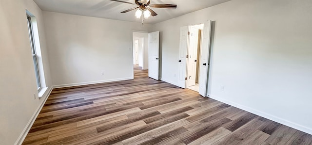 spare room featuring hardwood / wood-style floors and ceiling fan