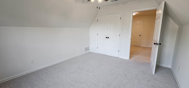 bonus room with light carpet, ceiling fan, and vaulted ceiling