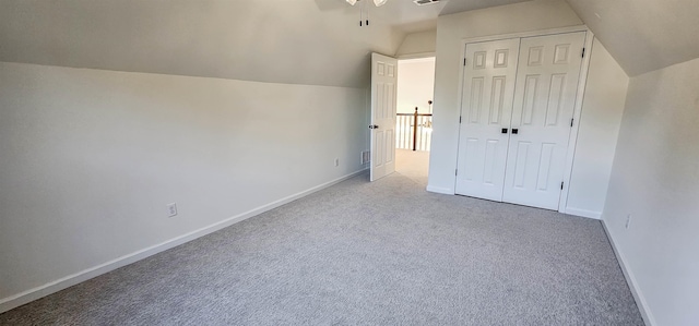 bonus room featuring lofted ceiling and light carpet