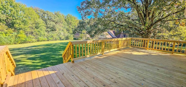 wooden terrace featuring a yard