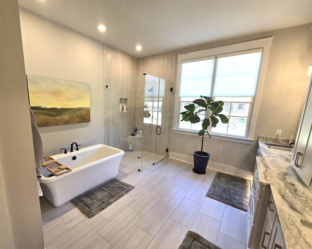 bathroom featuring vanity and separate shower and tub