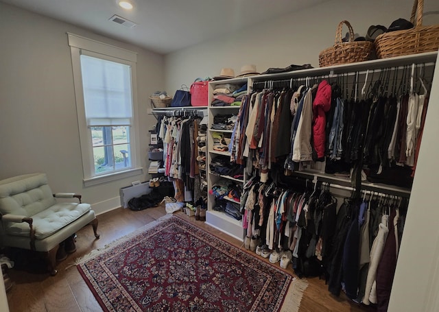 spacious closet with hardwood / wood-style floors