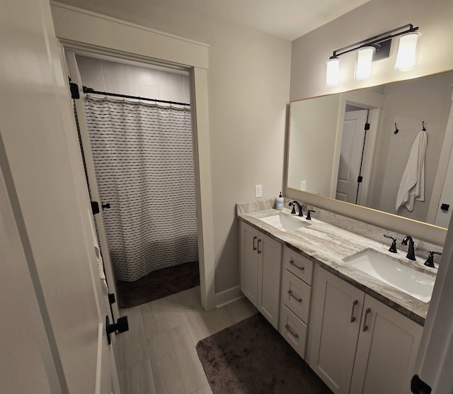 bathroom with vanity, hardwood / wood-style floors, and walk in shower