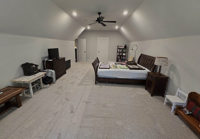 bedroom featuring vaulted ceiling, light colored carpet, and ceiling fan