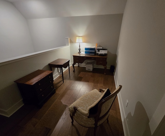 sitting room featuring dark wood-type flooring and lofted ceiling