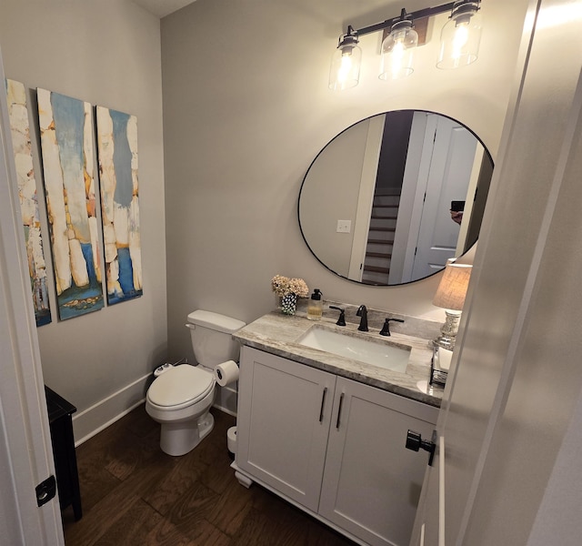 bathroom featuring vanity, toilet, and hardwood / wood-style flooring