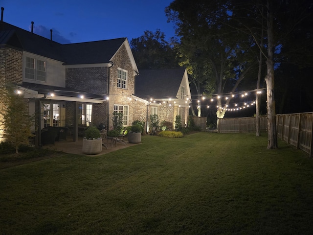 yard at twilight with a patio area