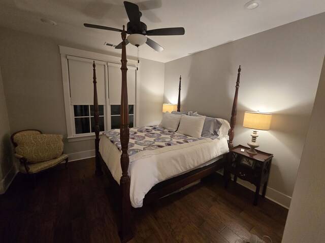 bedroom with dark wood-type flooring and ceiling fan