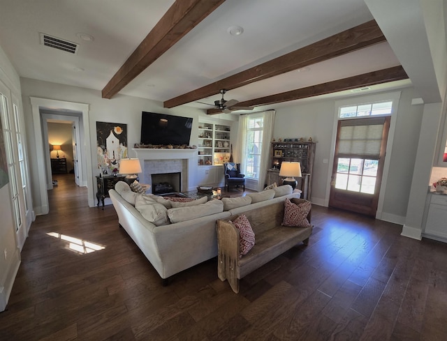 living room with ceiling fan, beamed ceiling, and dark hardwood / wood-style flooring