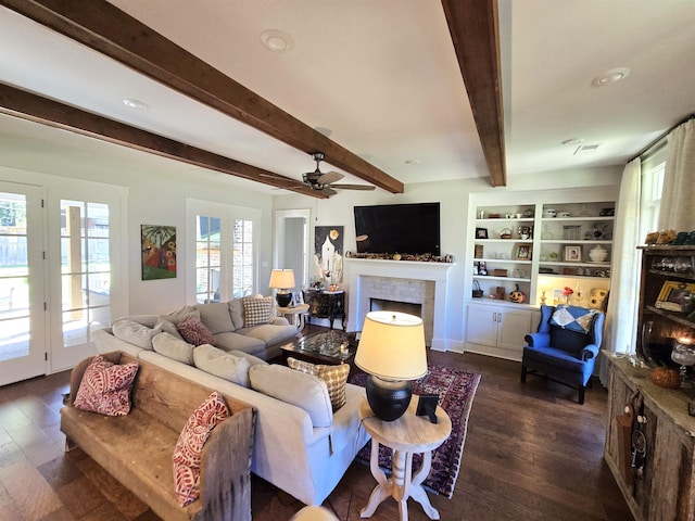 living room with dark hardwood / wood-style floors, beamed ceiling, and ceiling fan