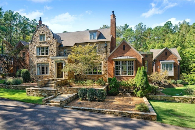 tudor home featuring a front yard