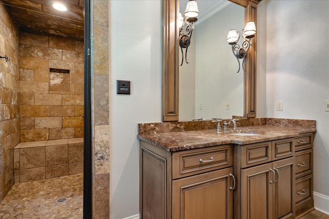 bathroom featuring vanity, crown molding, and tiled shower