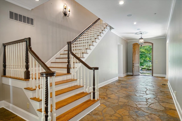 foyer featuring ornamental molding