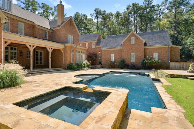 view of swimming pool featuring an in ground hot tub and a patio