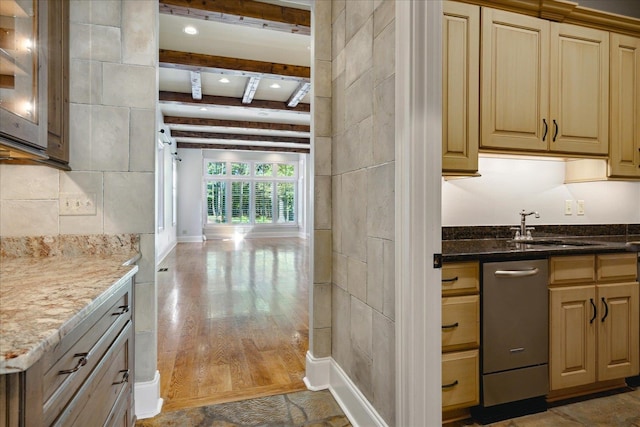 kitchen featuring light stone countertops, beam ceiling, hardwood / wood-style flooring, and sink