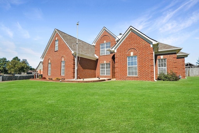 back of property featuring a lawn