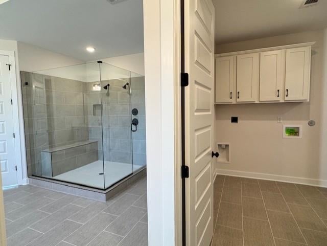 bathroom with tile patterned floors and walk in shower