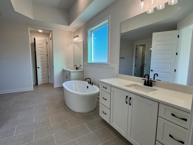 bathroom featuring plus walk in shower, tile patterned flooring, and vanity