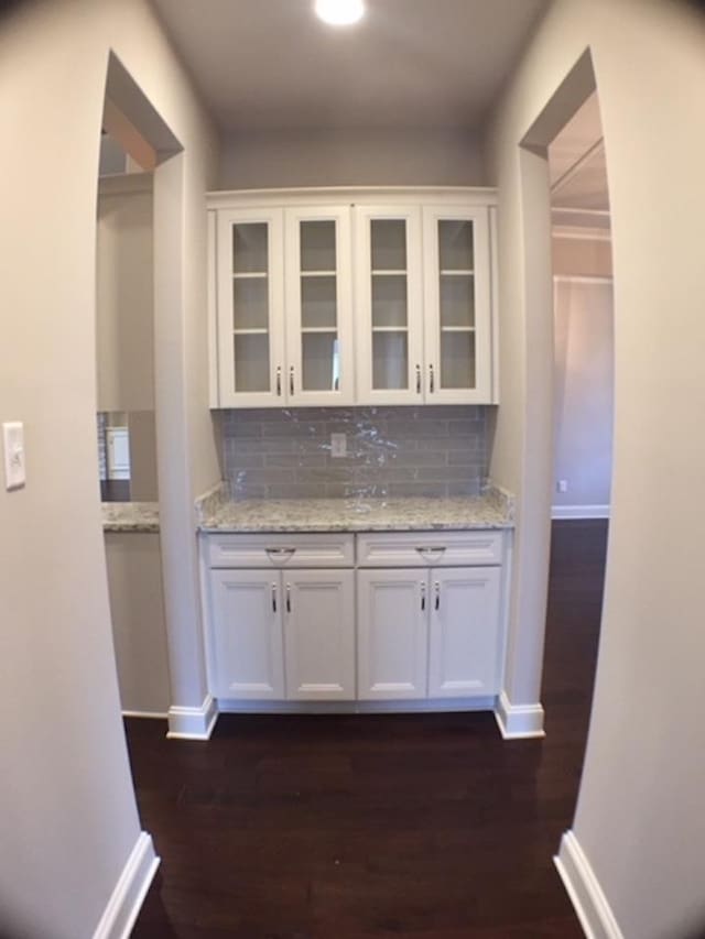 kitchen with light stone counters and white cabinets