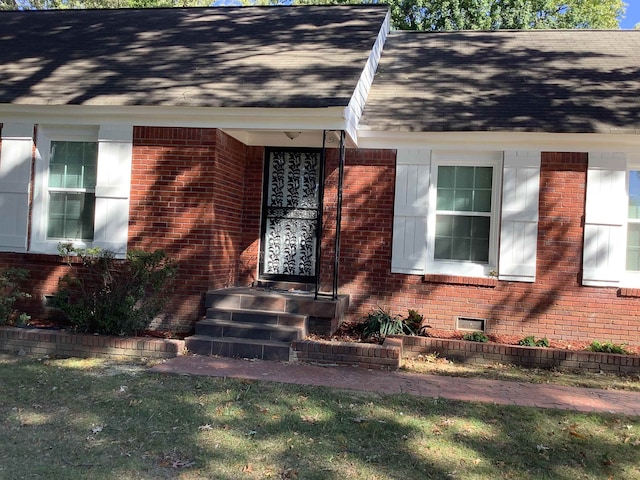 doorway to property with a yard