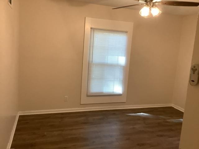 empty room with ceiling fan and dark hardwood / wood-style flooring