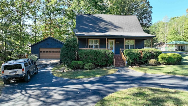 view of front of house featuring an outdoor structure, covered porch, a garage, and a front lawn