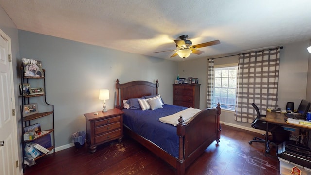 bedroom with ceiling fan, a textured ceiling, and dark hardwood / wood-style floors