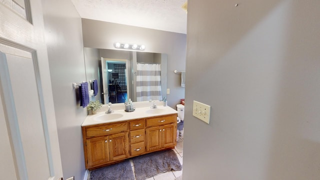 bathroom featuring vanity, a textured ceiling, and tile patterned floors