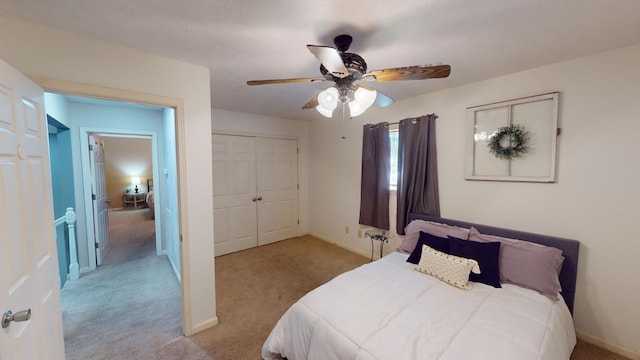 bedroom with light carpet, a closet, and ceiling fan