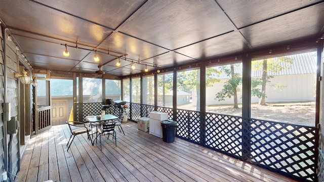 unfurnished sunroom featuring a water view and plenty of natural light